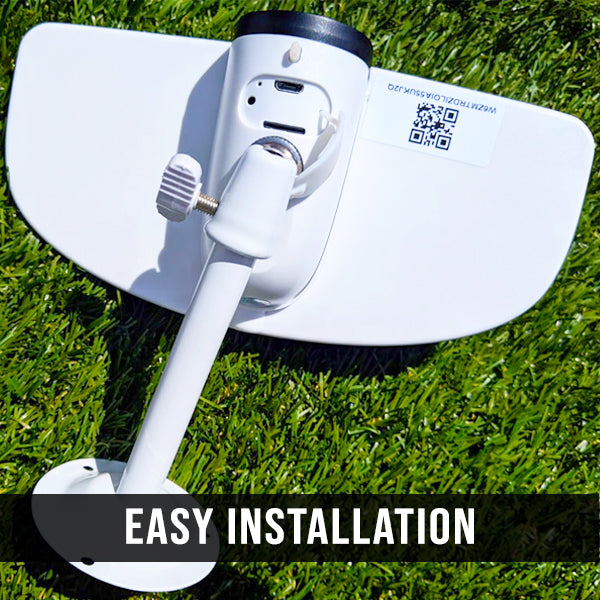 White outdoor security camera with mounting bracket on grass, labeled 'Easy Installation'