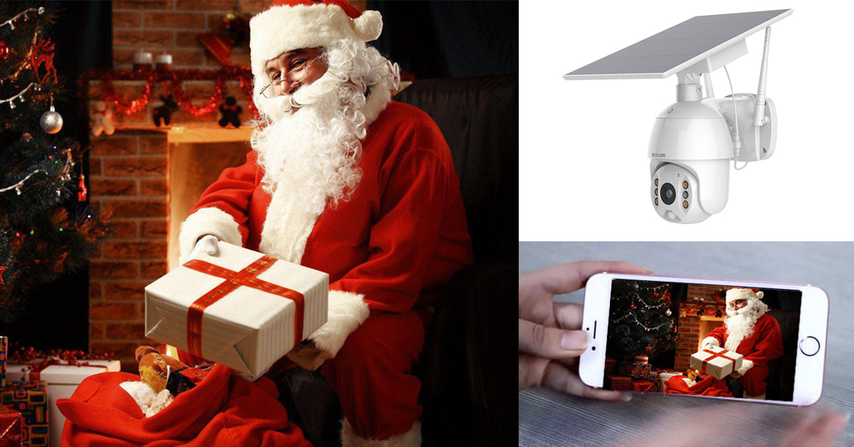 Santa Claus holding a Christmas gift by a decorated tree and fireplace, shown on a smartphone with solar security camera