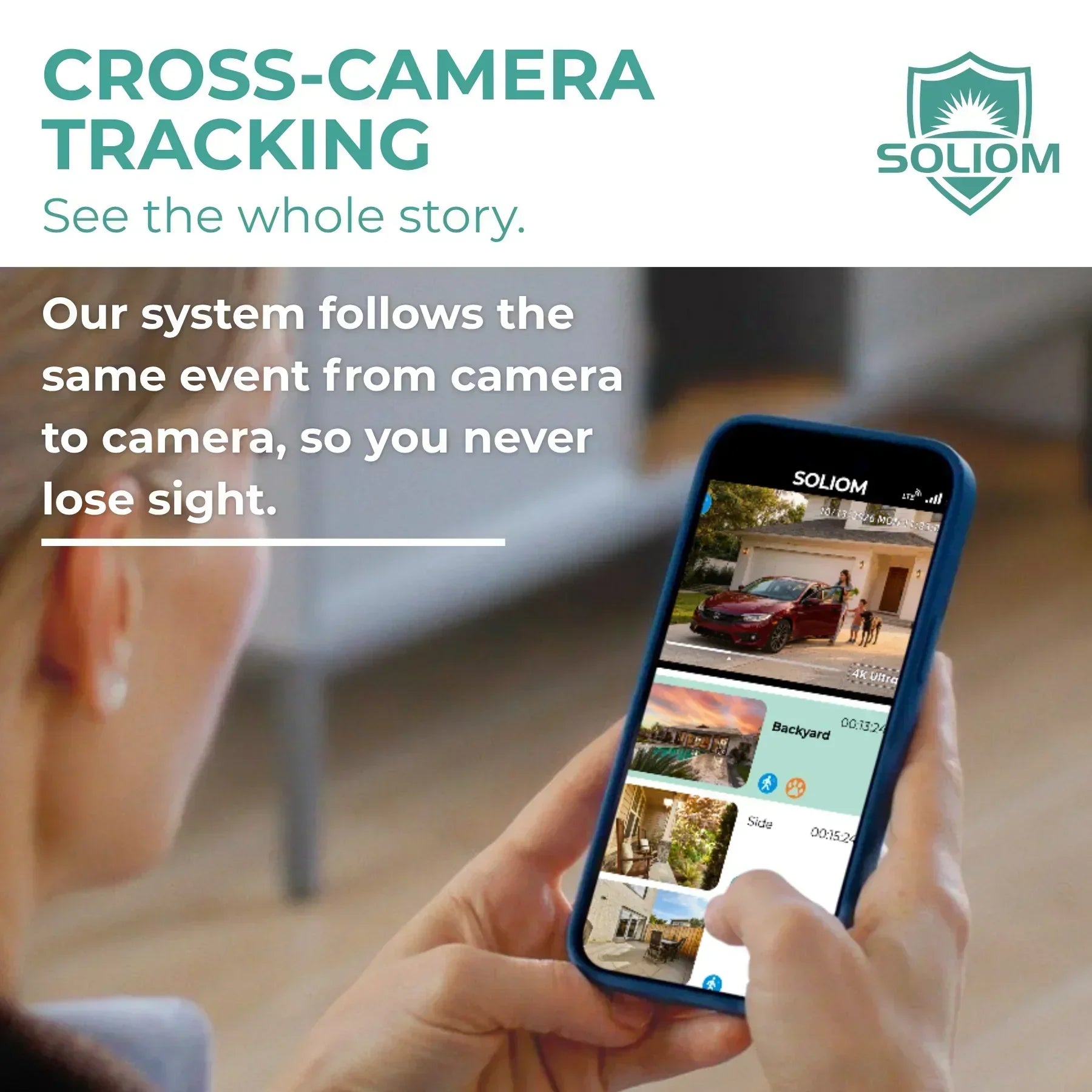 Person using smartphone app to monitor outdoor security cameras with cross-camera tracking feature.
